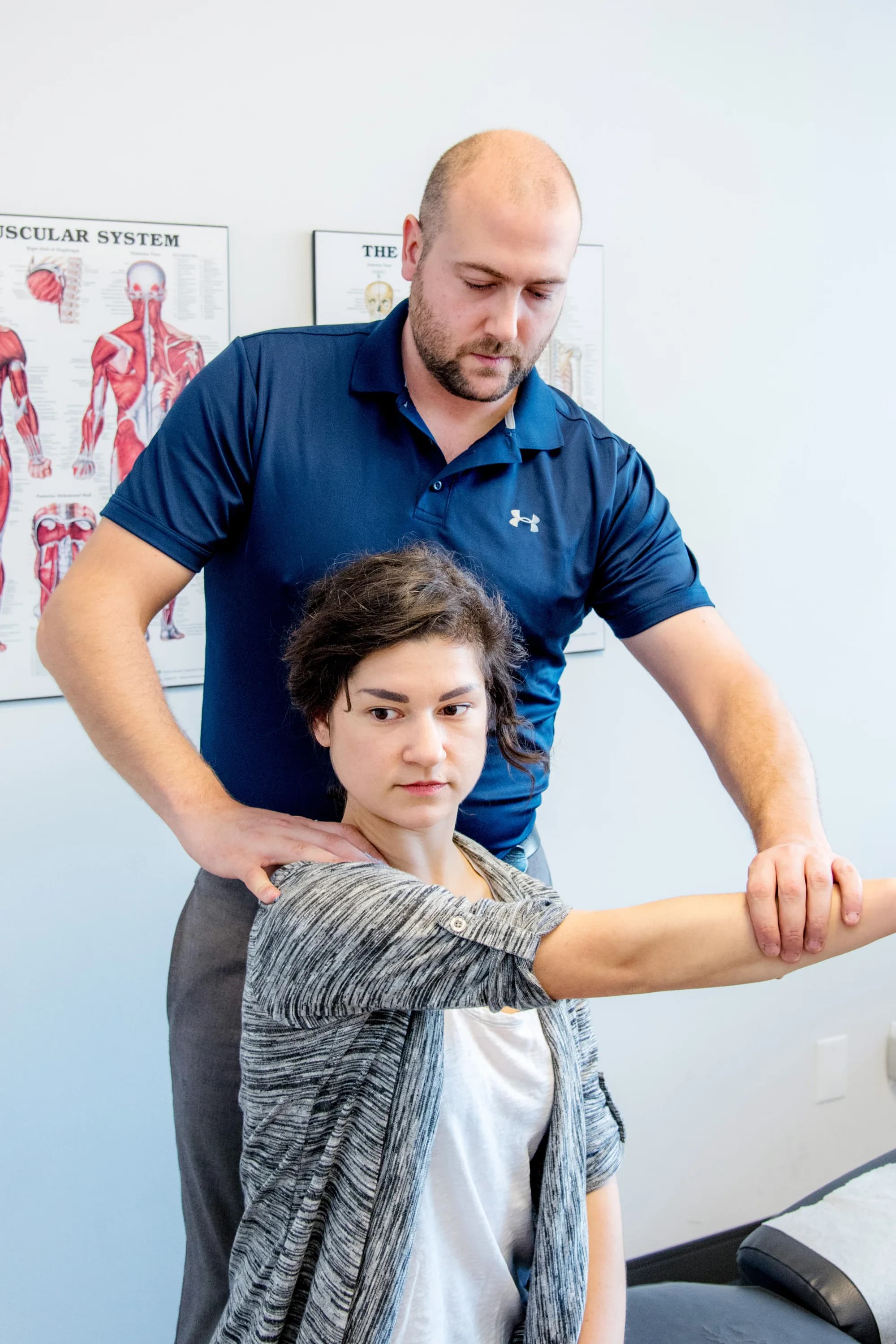 Practitioner performing a myofascial release and shoulder assessment