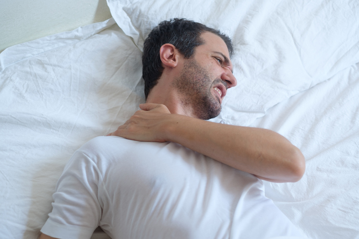 Man feeling back ache in the bed after sleeping